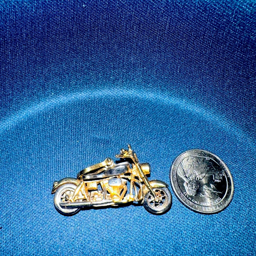 14kt solid Motorcycle with move able parts. Diamond headlight ruby taillight.